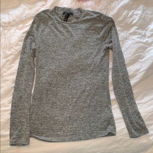 Long sleeve mock neck gray knitted shirt.